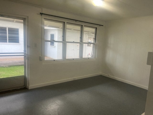 an empty room with a window and a door